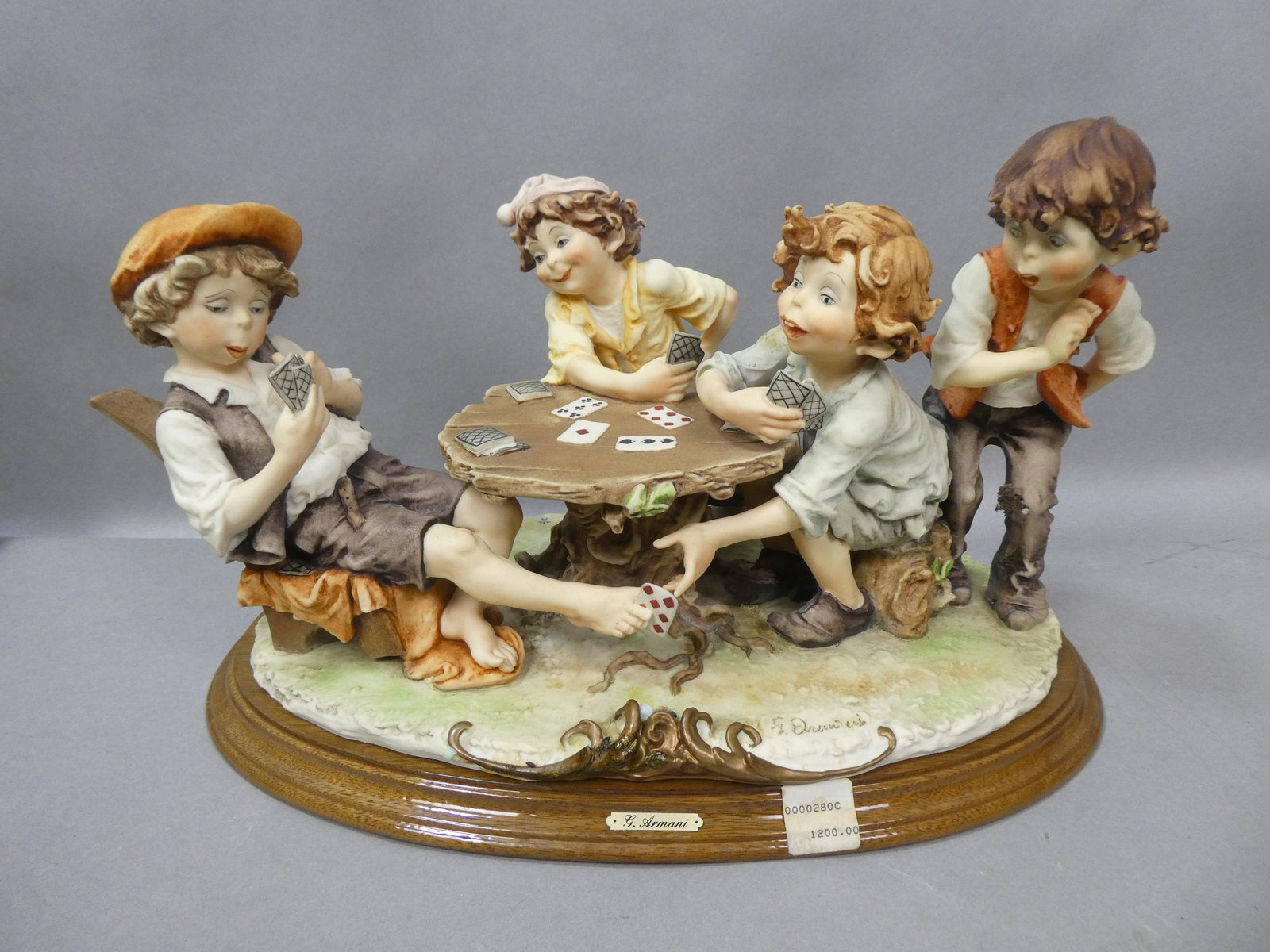 Florence Giorgio Armani Kids Playing Poker Sculpture: Florence Giorgio Armani Kids Playing Poker Sculpture. Measurements in inches: 10 high x 16 x 10 Condition:No chips, cracks or repairs, needs a cleaning Shipping:We offer in-house shipping. Item(s) wil