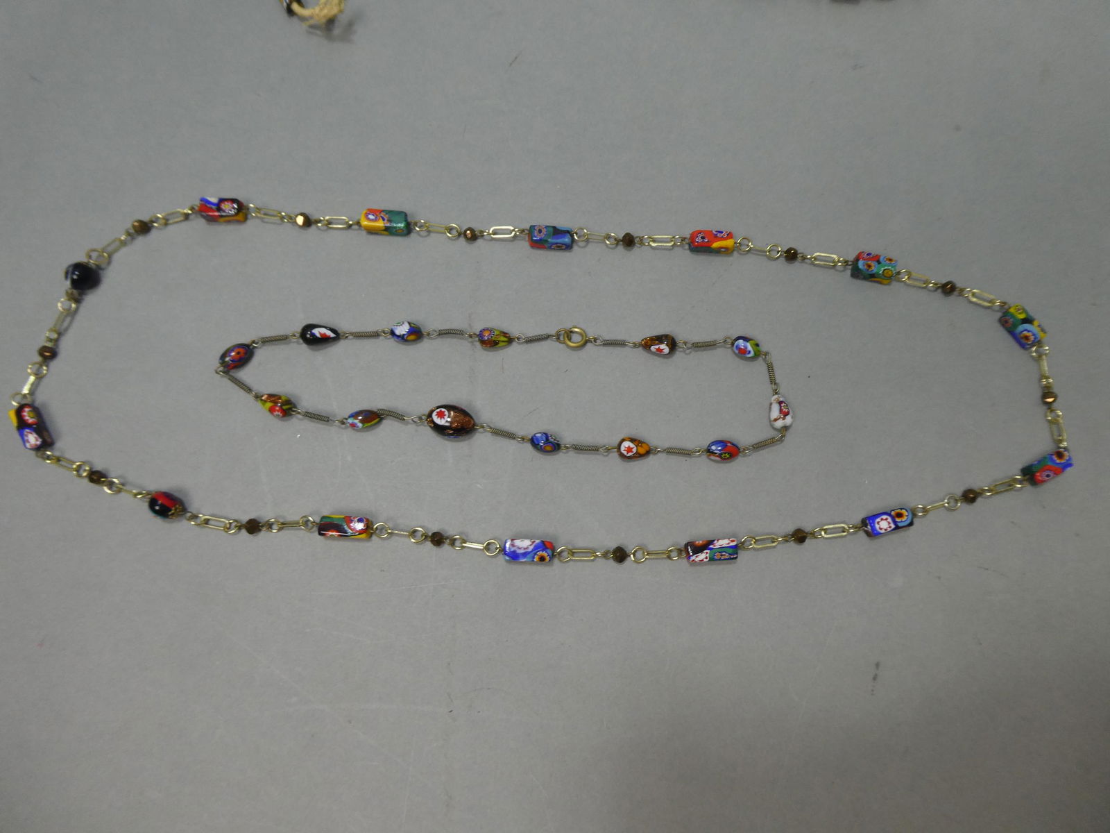 Pair Venetian Millefiori Glass & Metal Beaded Necklaces: Pair Venetian Millefiori Glass & Metal Beaded Necklaces. Measurements in inches: 35 and 16 long Condition:Normal wear with age and use Shipping:We offer in-house shipping. Item(s) will be packed after