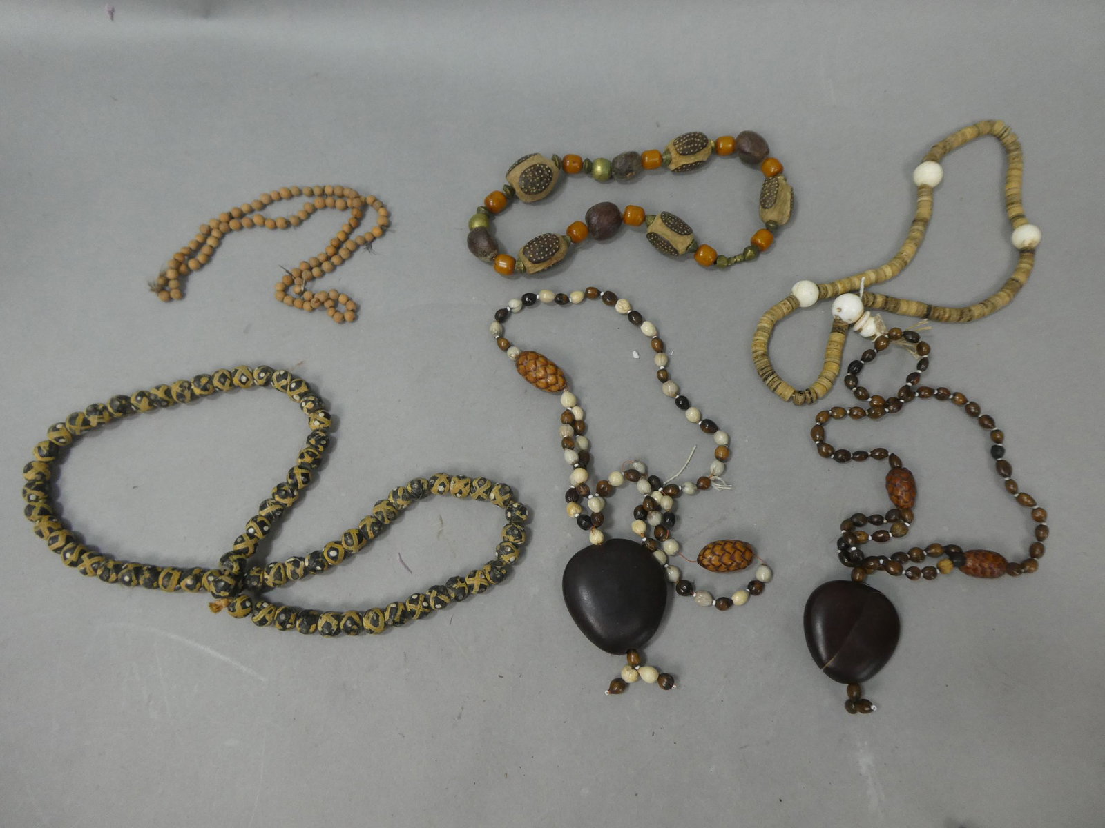 Lot 6 Antique African Trade Beaded Necklaces Cared Wood Nut Seed Glass Bone etc: Lot 6 Antique African Trade Beaded Necklaces Cared Wood Nut Seed Glass Bone etc. Condition:One pendant is cracked, general wear Shipping:We offer in-house shipping. Item(s) will be packed after invoic