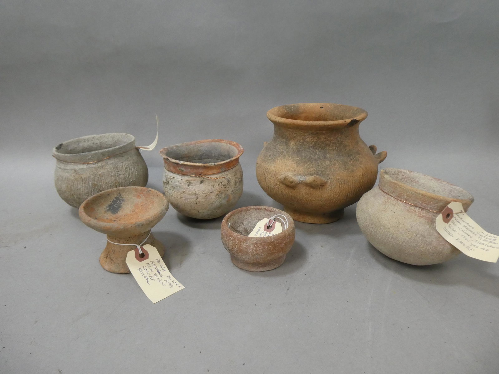 Lot 6 Repro Banchiang Culture Khort Plateau Ban Ching Thailand Vessels: Lot 6 Repro Banchiang Culture Khort Plateau Ban Ching Thailand Vessels. Measurements in inches: 3 1/4 to 7 diameter Condition:Not original, made to look old Shipping:We offer in-house shipping. Item(s
