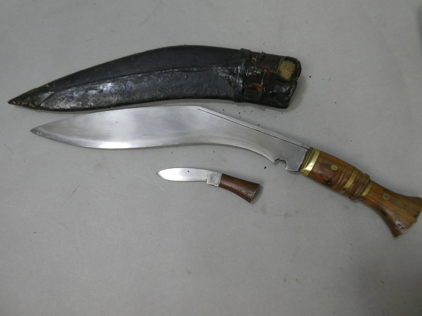 WWII Era Gurka Kukri Knife, Mini Knife & Scabbard: WWII Era Gurka Kukri Knife, Mini Knife & Scabbard. Measurements in inches: 16 long Condition:Normal wear with age and use Shipping:We offer in-house shipping. Item(s) will be packed after invoice is p