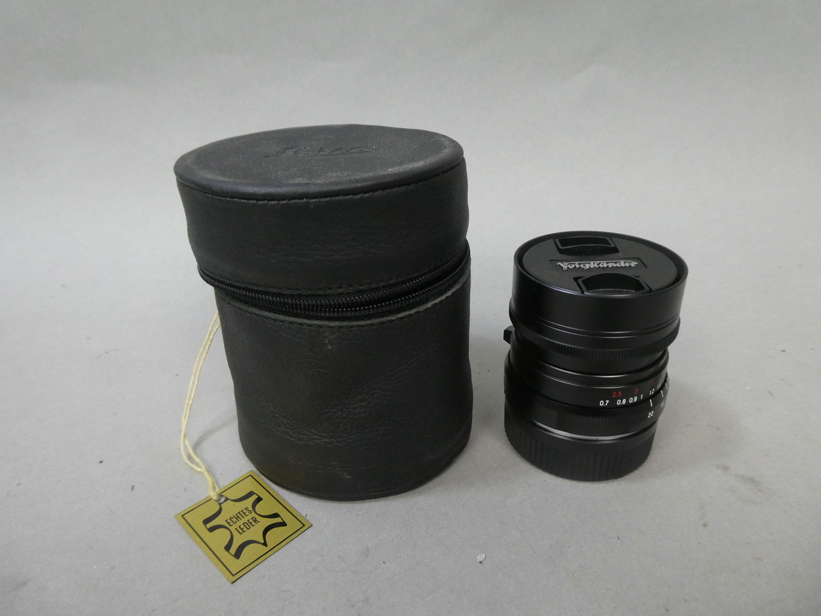 Voigtlander Ultron 28mm F2 Lens in Case: Voigtlander Ultron 28mm F2 Lens in Case This item is from a Gurnee, IL private estate. The estate included lots of cameras and accessories, motorcycles and parts, vehicles, knives, guns, tools, worksh