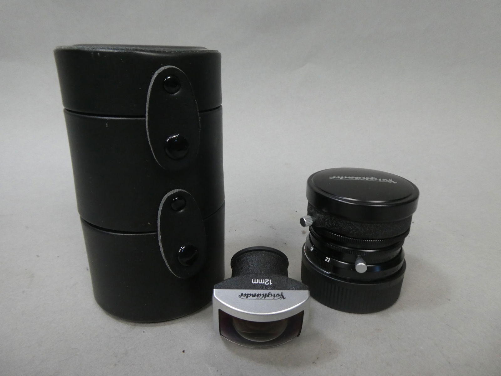 Voigtlander Ultra Wide-Heliar 12mm F5.6 Aspherical Lens & 12mm Viewfinder in Case: Voigtlander Ultra Wide-Heliar 12mm F5.6 Aspherical Lens & 12mm Viewfinder in Case This item is from a Gurnee, IL private estate. The estate included lots of cameras and accessories, motorcycles and pa