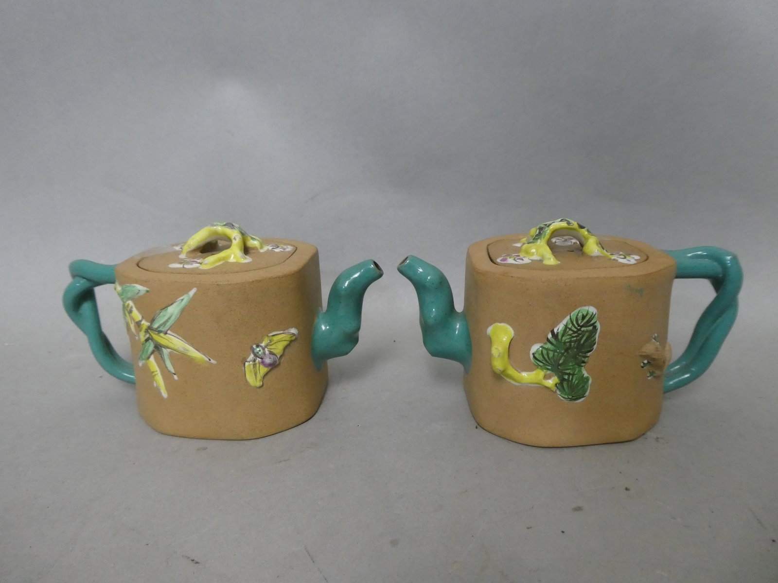 Pair Antique Beige Color Yixing Chinese Stoneware Teapots: "Beige stoneware with turquoise sprout and handle with famille rose colors on finial.