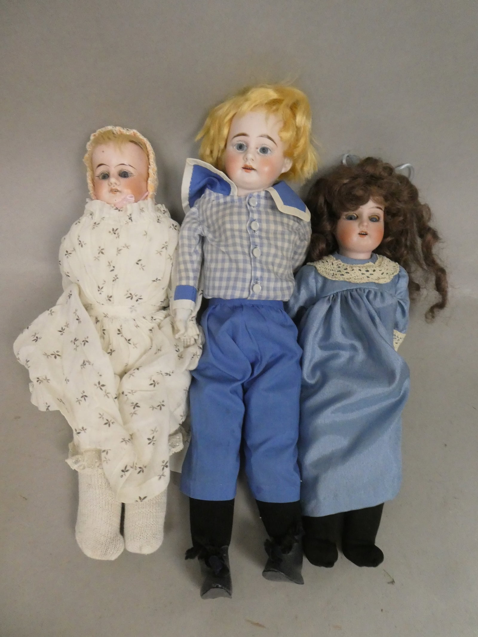 Lot 3 Antique Porcelain Head Soft Body Dolls German Lily Armand Marseille Boy Wiefel & Co: Lot 3 Antique Porcelain Head Soft Body Dolls including Armand Marseille boy, Weifel & Co girl and German Lily in blue. Measurements in inches: 12,13 and 15 high Condition:Normal wear with age and use 