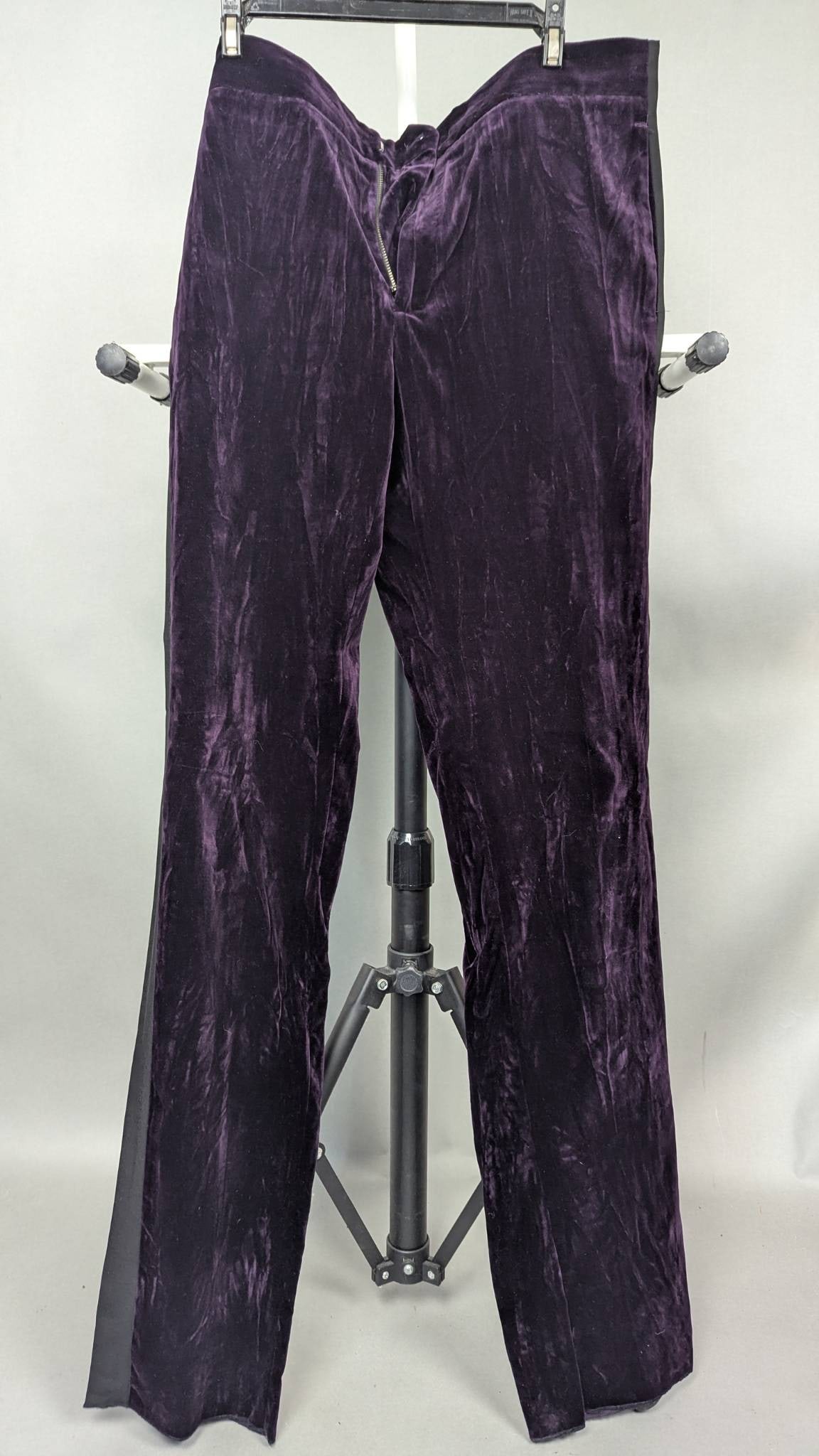 Roberto Cavalli Purple Velvet Tailored Classic Fit Pants: Roberto Cavalli men's tailored classic-fit pants crafted from luxurious purple velvet. Featuring a zipper fly and dual rear welt pockets. The pants are partially constructed with a gray contrast fabri