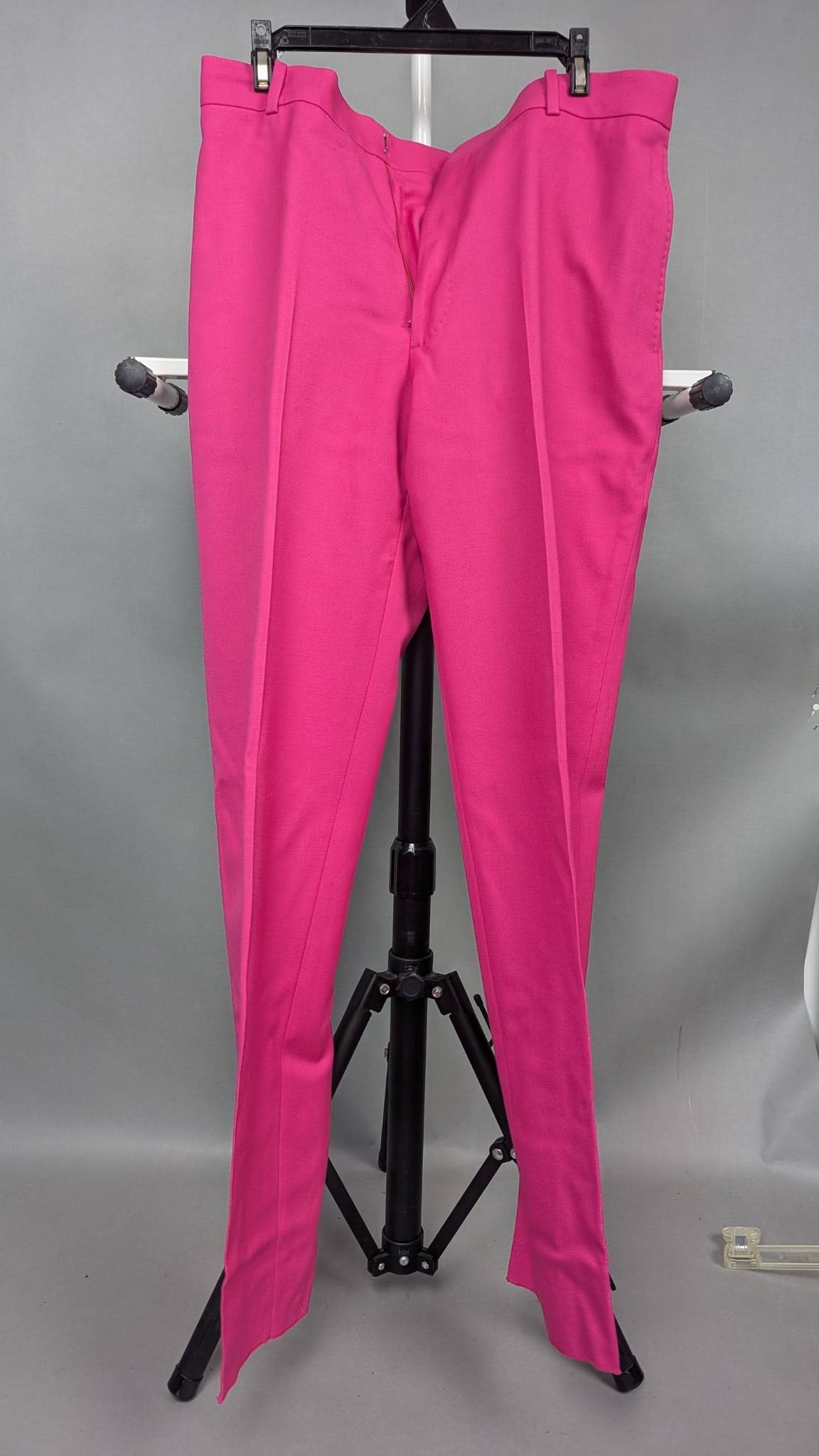 Alexander McQueen Pink Slim-Fit Trousers Made in Italy: Alexander McQueen tailored slim-fit trousers in vibrant pink, made in Italy. Features include a zip fly with hook-and-bar closure, belt loops, back buttoned welt pockets, and a flat front design. Size