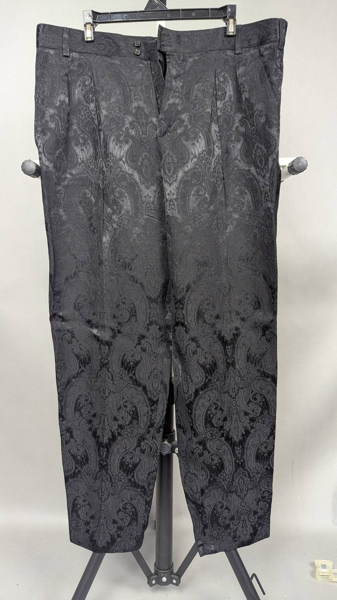 Saint Laurent Paris Black Jacquard Patterned Trousers: Saint Laurent Paris black trousers featuring a jacquard paisley-inspired pattern. Made in Italy, these trousers are crafted from premium materials, with a tag indicating size 52 (EU). Includes button 
