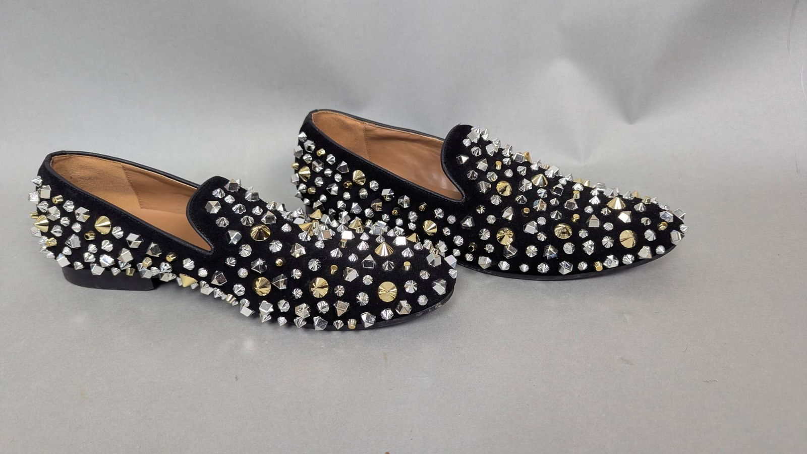 Mens Black Studded Sandro-1 Loafers, Size 10.5M, Leather Upper: Men's loafers, labeled as 'Sandro-1,' featuring a black leather upper adorned with gold and silver studs. Interior lining is man-made, and the outsole is rubber. Size 10.5M. Condition shows visible we