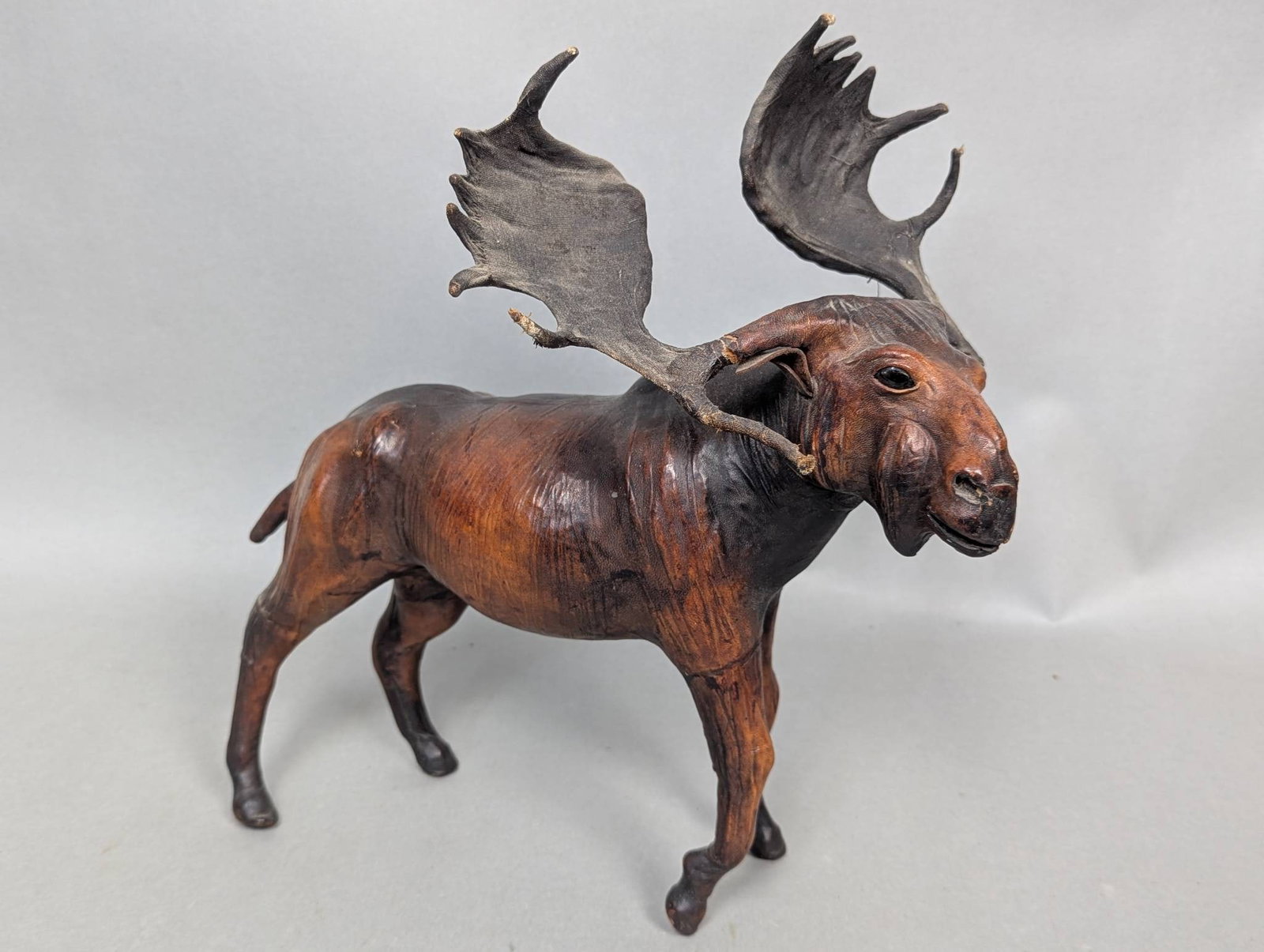 Vintage Leather Moose Sculpture Figure w/ Antlers: Vintage moose sculpture crafted from leather, measuring approximately 14 inches high, 9 inches wide, and 14 inches long. Features realistic details including intricately formed antlers. Shows visible 