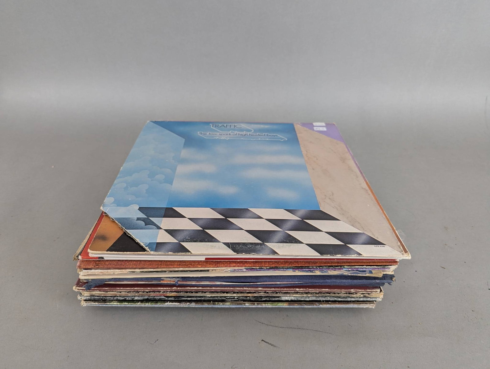 Collection of Vinyl Record Albums Featuring Various Artists and Genres: This lot consists of a mixed selection of vinyl record albums, featuring a variety of artists, genres, and themes. Titles and artists included in the collection are The Beatles Revolver, The Beatles R