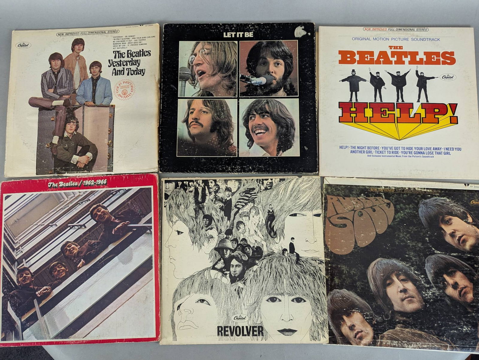 Collection of Beatles Records Including Let It Be and Revolver: This lot features a collection of Beatles records, including the following titles: The Beatles Yesterday and Today, Let It Be, Help, 1967-1970, Revolver, Meet The Beatles, and Magical Mystery Tour. Th
