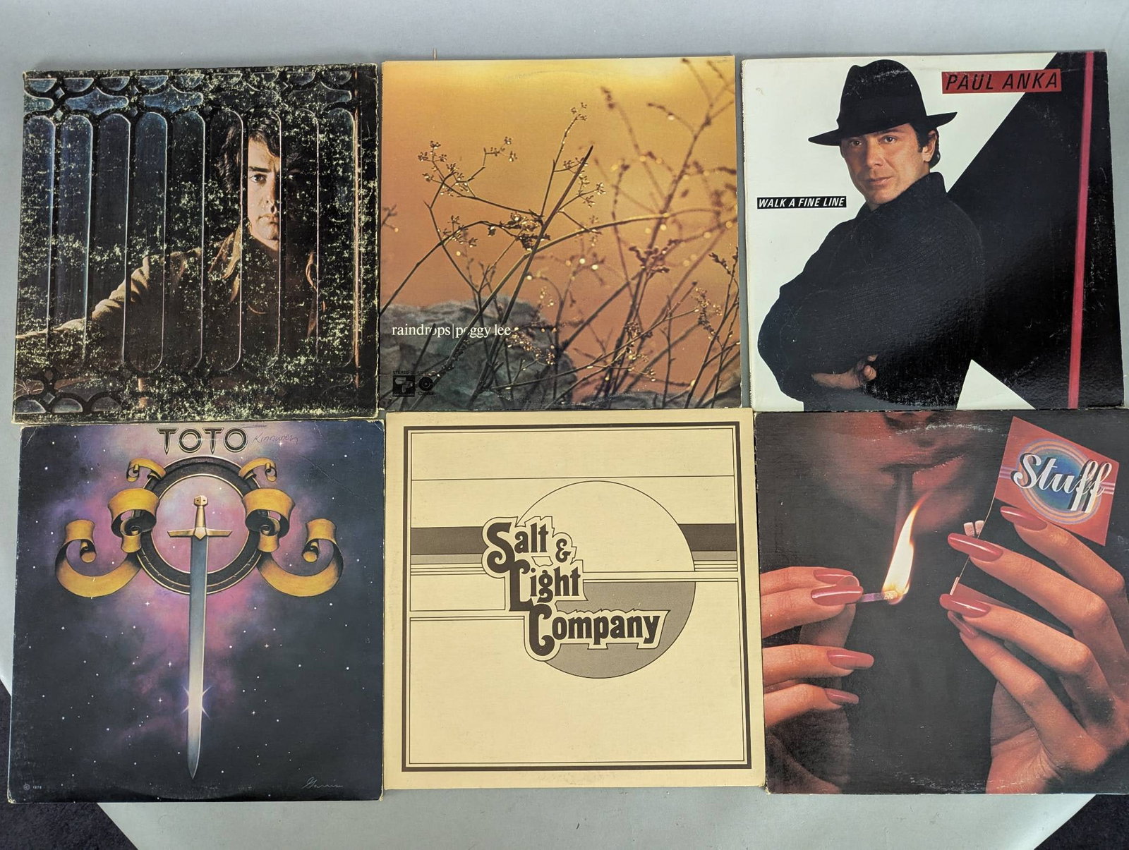 Lot of 48 Record Albums Featuring Various Artists and Titles: This lot comprises 48 record albums featuring diverse artists and titles across genres and eras. Albums include notable works such as Toto, Johnny Cash, Styx, Sarah Vaughan, The Sound of Music, Jesus 