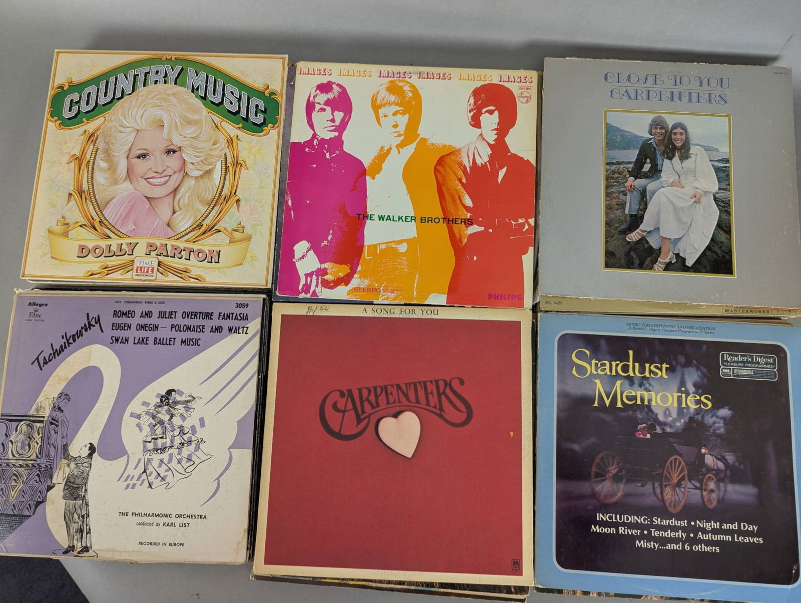 Lot of 48 Record Albums Including Dolly Parton and Carpenters: This lot consists of 48 vinyl record albums from various artists and genres. Notable albums include works by Dolly Parton, The Carpenters, Oak Ridge Boys, Boots Randolph, and Mike Douglas. Recordings