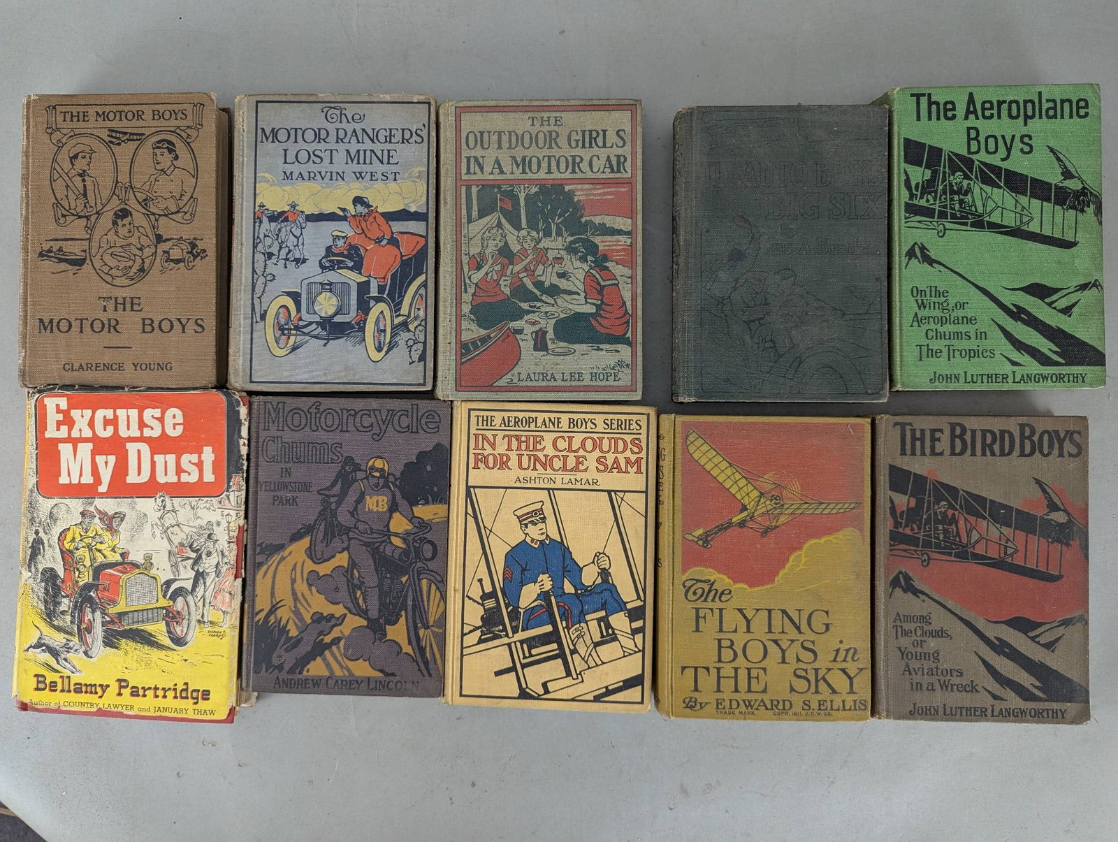 Collection of Early 20th Centure Automobile Morterycle & Airplane Adventure Books: A collection of ten early 20th-century adventure and aviation-themed books, showcasing diverse titles and thematic associations. The titles include The Motor Boys by Clarence Young, The Motor Rangers 