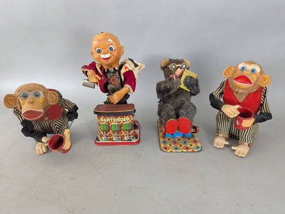 Tin Battery-Operated Japan Toys Including Monkeys Bear and Bartender: Lot of four tin battery-operated toys from Japan, featuring two monkeys, one bartender figure, and a bear. The two monkeys include striped outfits with red vests, holding mugs and showing signs of vin