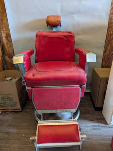 Vintage 1961 Paidar Barber Chair with Red Upholstery and Chrome Frame: A vintage 1961 Paidar barber chair manufactured by the Emil J. Paidar Company of Chicago. Features include a red padded leather seat, backrest, armrests, and footrest. The chair has a chrome metal fra
