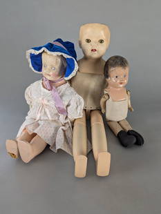 Lot of Three Early 20th Century Composite and Cloth Dolls: Group of three dolls with painted composite heads, cloth bodies, and jointed limbs. Includes a 2-inch doll with painted blue eyes and red lips, wearing a cloth camisole-style bodice. The 22 high x 7 w