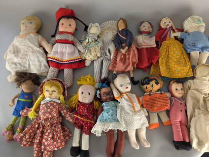 Collection of Handmade and Cloth Dolls with Various Outfits: Collection of handmade and cloth dolls featuring a diverse range of designs and outfits. Includes dolls dressed in regional garments, brightly patterned dresses, and various themes. Notably, the