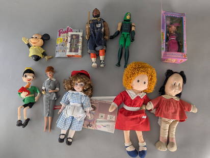 Collection of Assorted Dolls and Action Figures Including Barbie and Annie: Lot includes a variety of vintage and modern dolls and action figures. Items consist of a Lucy doll dressed in a checked outfit, an Annie plush doll with red dress, another Annie-themed cloth doll, a