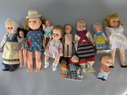 Assorted Collection Rubber Head Vintage Dolls in Various Styles and Sizes: Lot of assorted dolls in different styles, sizes, and materials. Includes a variety of dolls in traditional clothing, casual outfits, and some in boxed or preserved condition. Includes both