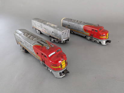 Set of Three Santa Fe Model Train Engines by Lionel. 2333-20 etc: Set of three Santa Fe model train engines manufactured by Lionel, including two red and silver diesel locomotives and one silver companion unit. Each unit is constructed of metal with detailed paintwo