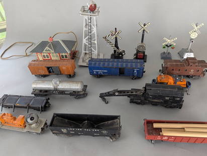 Lionel Train Cars and Accessories Collection with Track Signals: Collection of Lionel vintage train cars and accessories, including Lehigh Valley and NYC gondolas, a Lionel Lines tank car, a caboose, a flat car with accessories, and a crane car. Also included are a