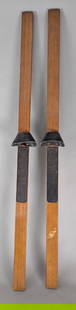 Vintage Wooden Skis with Metal Bindings from Mid-20th Century: Pair of vintage wooden skis estimated to date from the 1930s or later. Made from wood, possibly hickory or a similar hardwood, these skis feature grooved footpads for improved grip and metal bindings