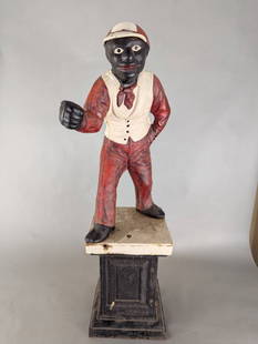 Original Antique Cast Iron Lawn Jockey 38 high: Original antique cast iron lawn jockey statue measuring 38 inches high by 10 deep inches by 10 wide inches. The face has been repainted, and the figure is missing its ring. The sculpture features a ma