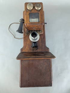 Chicago Electric Supply Oak Candlestick Wall Telephone: Chicago Electric Supply wall telephone constructed of oak with a candlestick receiver and mouthpiece. The piece measures 32 high x 13 deep x 11 wide. Features dual metal bells and a glass Windo, wirin