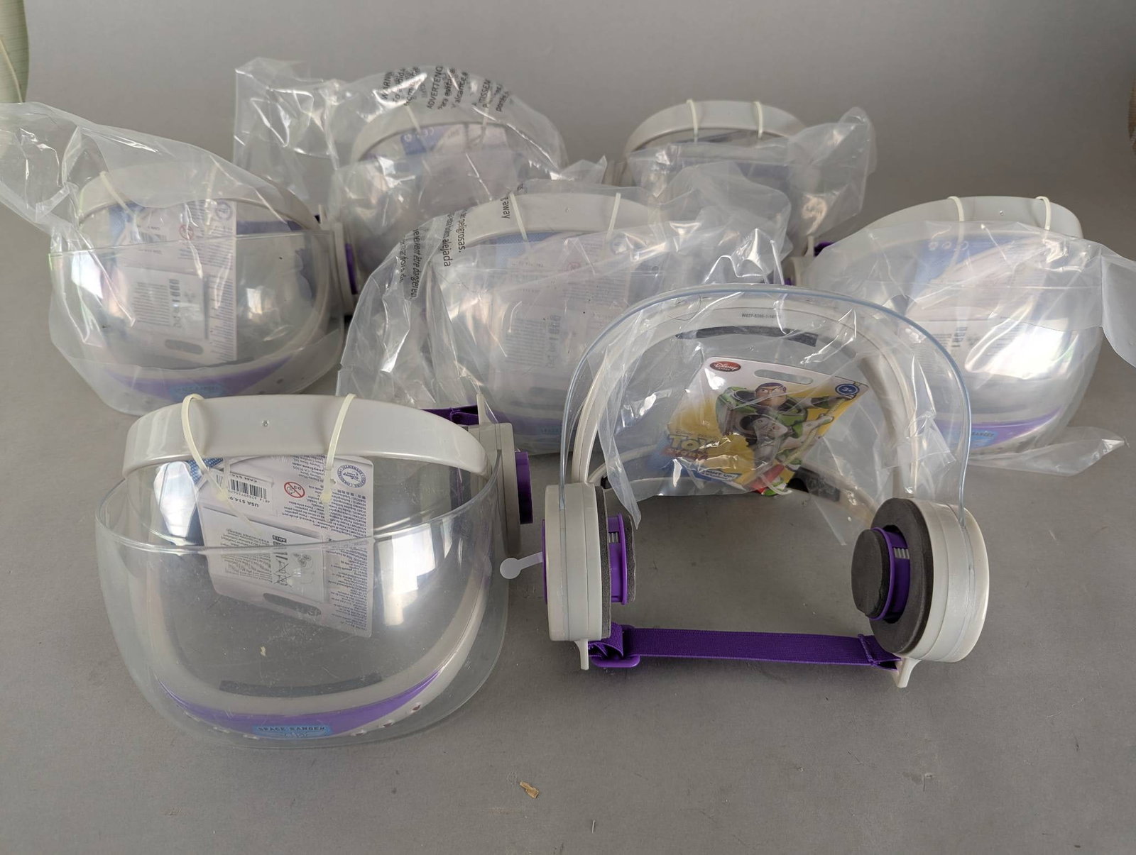 7 Disney Toy Story Buzz Lightyear Light-Up Helmets New: 7 Disney Toy Story Buzz Lightyear light-up helmets. Each helmet features a clear visor, purple and gray accents, and is branded with Disney Pixar Toy Story detailing. The helmets are new and packaged,