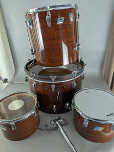 4 piece Ludwig Mahogany Cortex Wood Drum Set with Blue and Olive Badges: Ludwig four-piece drum set featuring mahogany cores with laminate cortex covering, likely manufactured in the 1970s or early 1980s. Drum sizes are 16 high x 23 wide x 23 deep (bass drum), 20 x 16 diam