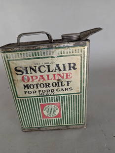 Sinclair Opaline Motor Oil One Gallon Tin with Spout: Sinclair Opaline Motor Oil tin container with a capacity of one gallon, designed for Ford cars. Made of metal, the tin features vibrant printed labeling with green and white striped accents, showcasin