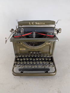 LC Smith and Corona SecretarialÂ  Manual Typewriter with Olive Finish: LC Smith and Corona manual typewriter with olive green finish and metal construction. Includes decal text reading LC Smith and Corona Typewriters Inc from Syracuse NY. The typewriter measures approxim
