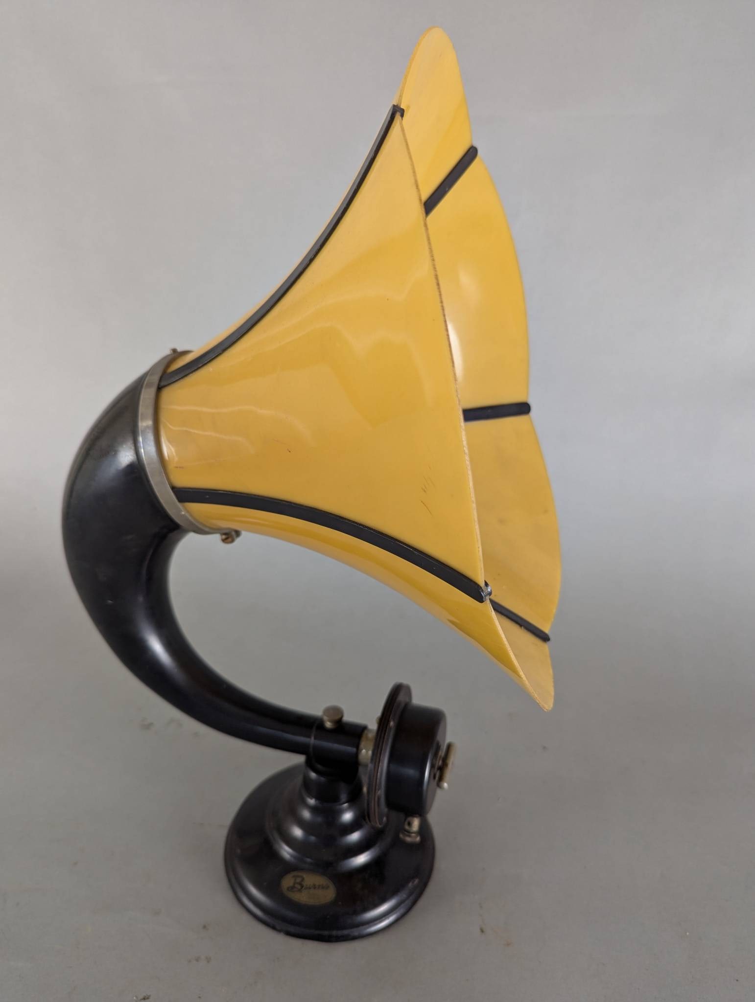 Antique Burns Horn Speaker in Yellow Celluloid and Black Metal Finish: Burns horn speaker featuring a striking yellow celluloid horn with black metal accents. Measuring 21 inches high and 12 x 13 inches in width and depth, this speaker showcases a bold and elegant design