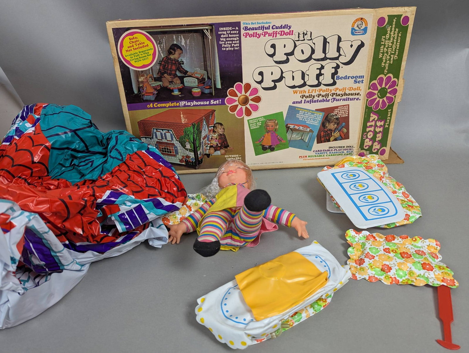 Vintage Lil Polly Puff Playset with Doll and Inflatable Furniture: Lil Polly Puff Playset featuring an original Polly Puff doll, playhouse, playset accessories, and inflatable furniture. Box shows wear consistent with age. Included components such as the inflatable f