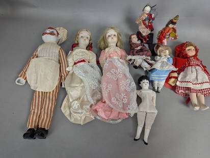 Lot of Bisque China and Porcelain Dolls with Various Outfits: Bisque, china, and porcelain dolls, including one measuring 18 high x 6 wide x 3 deep in inches. The lot features a diverse assortment of dolls dressed in various outfits, ranging from lace dresses to