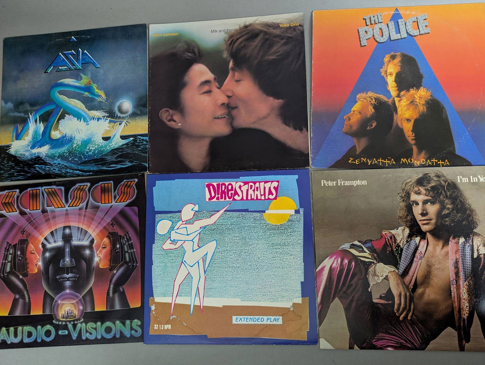 Vinyl Records Featuring Various Artists and Albums Who Yes Eagles etc: 15 vinyl records featuring albums from popular artists and bands. Included in the lot are titles such as "Asia" by Asia, "Double Fantasy" by John Lennon and Yoko Ono, "Zenyatta Mondatta" by The Police