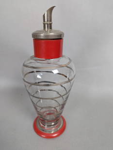 Czech Hand Blown Glass Art Deco Cocktail Shaker with Red Accents: Czech hand blown glass Art Deco cocktail shaker featuring a clear glass body with silver-colored spiral detailing. The shaker includes a silver-tone spout and lid, along with vibrant red accents on th