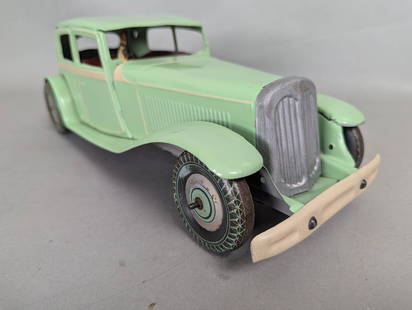 Mettoy Tin Wind-Up 1932 Riley 12/4 Kestrel Sedan: Mettoy tin wind-up toy car replicating a 1932 Riley 12/4 Kestrel Sedan. Dimensions are approximately 14 inches high, 6 inches wide, and 5 inches deep. This collectible model was one of the first cars
