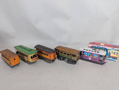 5 Tin O Gauge Trolley Passenger CarsÂ : Five tin O gauge trolley passenger cars, each approximately 8 inches long, 4 inches high, and 3 inches wide. Includes one boxed example. The lot features a variety of designs and paint schemes, showca