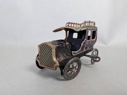 Vintage German Tin Litho Wind-Up Limousine Toy: A vintage German tin litho wind-up limousine toy, measuring 5 high x 3 wide x 2 deep. This wind-up tin lithographed car represents a limousine or sedan, showcasing detailed lithographed designs on its