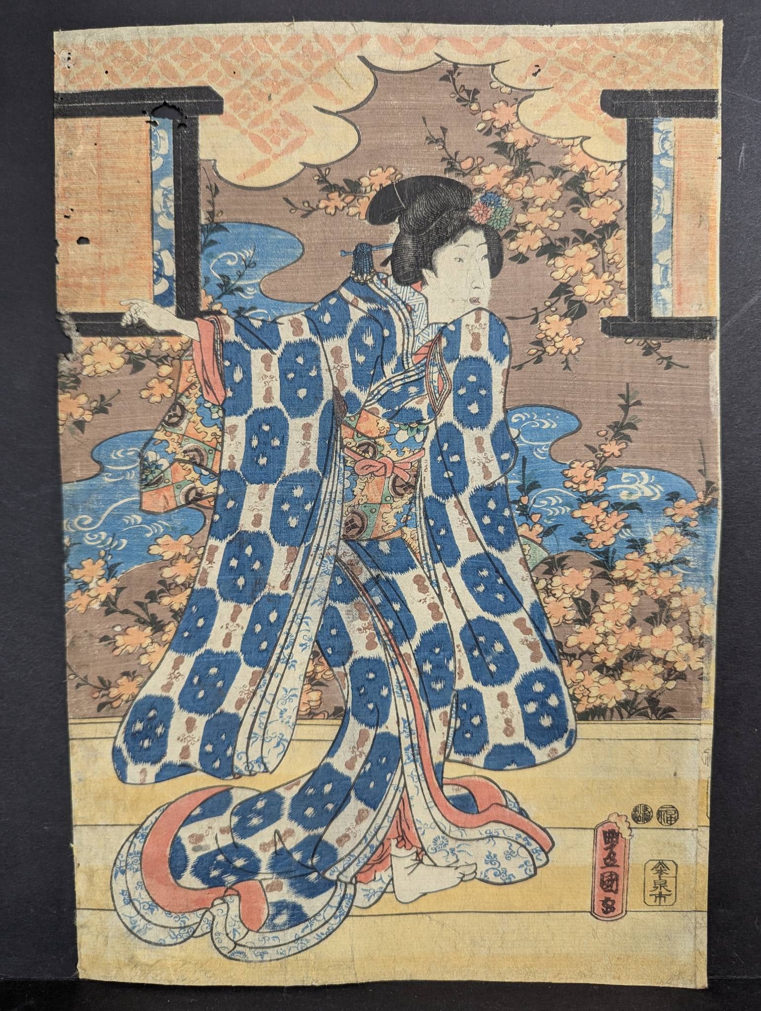 Japanese Woodblock Print Young Woman on a Veranda by Utagawa Kunisada/Toyokuni III 19th Century: Japanese woodblock print titled Young Woman on a Veranda by Utagawa Kunisada, created around 1849-1851. The print depicts a young woman in a vibrant kimono featuring intricate patterns, surrounded by 