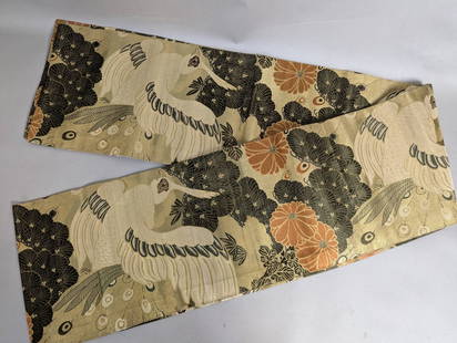 Japanese Textile Obi with Crane and Floral Motif: Japanese textile obi featuring a detailed design of cranes and floral patterns, crafted in shimmering gold tones with accents of black and orange. This traditional Japanese fabric is intricately woven