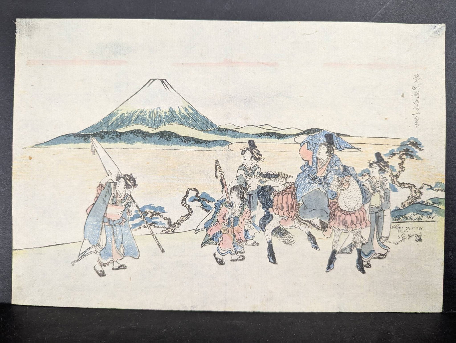 After Hokusai Japanese Woodblock Print Depicting Warriors and Mount Fuji: After Hokusai Japanese Woodblock Print depicting warriors in a procession with Mount Fuji in the background. The print features delicate details typical of Katsushika Hokusaiâ€™s styl