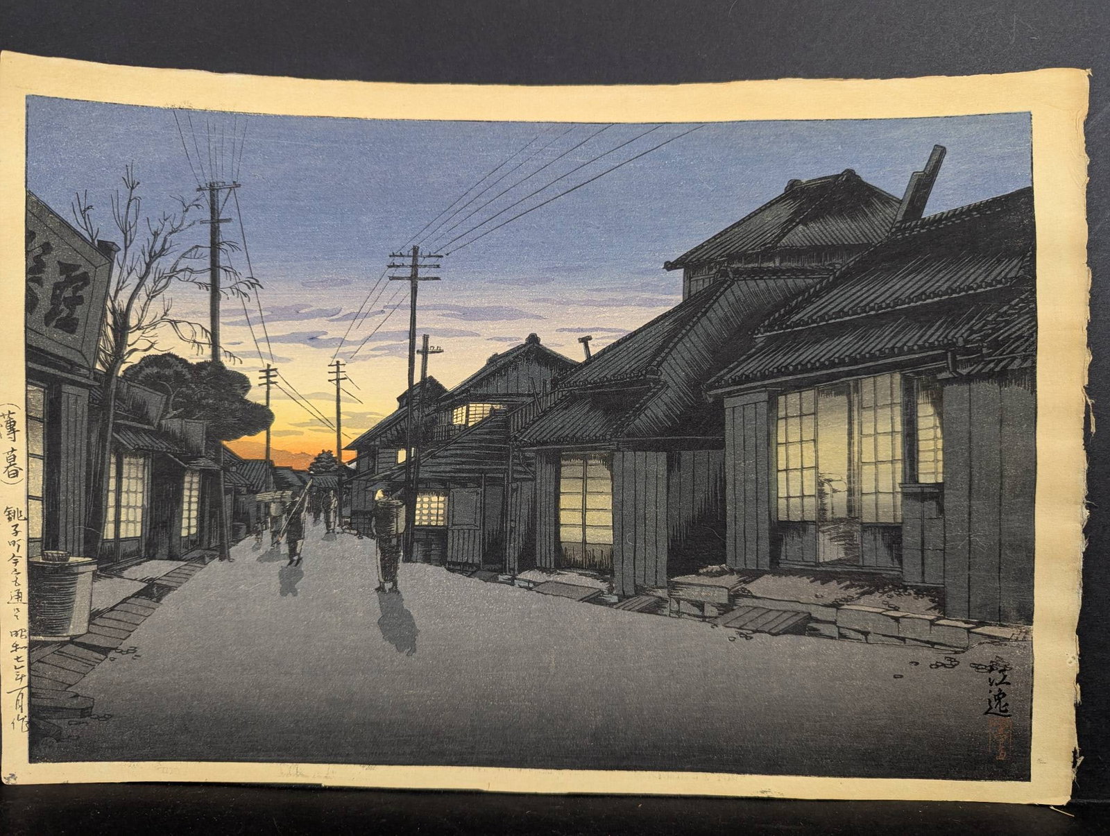 Japanese Woodblock Print Twilight at Imamiya Street Choshi by Koitsu Ishiwata: Japanese Woodblock Print titled Twilight at Imamiya Street Choshi, originally designed by Koitsu Ishiwata (1897-1987) in 1932 during the Shin Hanga movement. Known for his ability to capture delicate 
