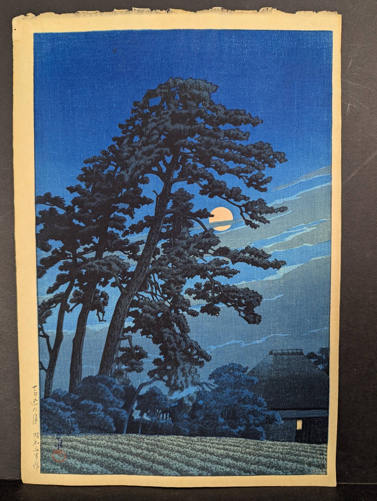 Japanese Woodblock Print Moon at Magome by Kawase HasuiÂ : Japanese woodblock print titled Moon at Magome by Kawase Hasui, originally created in 1930. This post-war impression measures 10 1/2 inches high by 15 inches wide. The image depicts a full moon partia