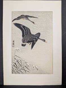 Japanese Woodblock Print Two White-fronted Geese Flying in Snow by Ohara Koson: Post-war Japanese woodblock print titled Two White-fronted Geese Flying in Snow by Ohara Koson (also known as Shoson). The artwork measures 10 3/4 x 15 1/2 inches and is accompanied by its original mo