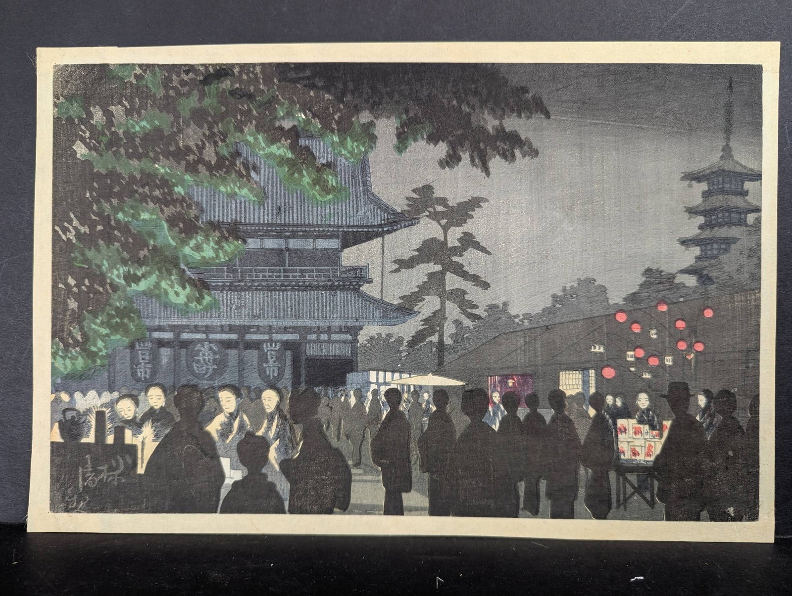 Japanese Woodblock Print Night Market at Asakusa 12 3/4 High x 8 3/4 Wide: Japanese woodblock print depicting the Night Market at Asakusa (Asakusa yomise), created in 1881 by the acclaimed ukiyo-e artist Kobayashi Kiyochika. This artwork portrays a lively nighttime market sc