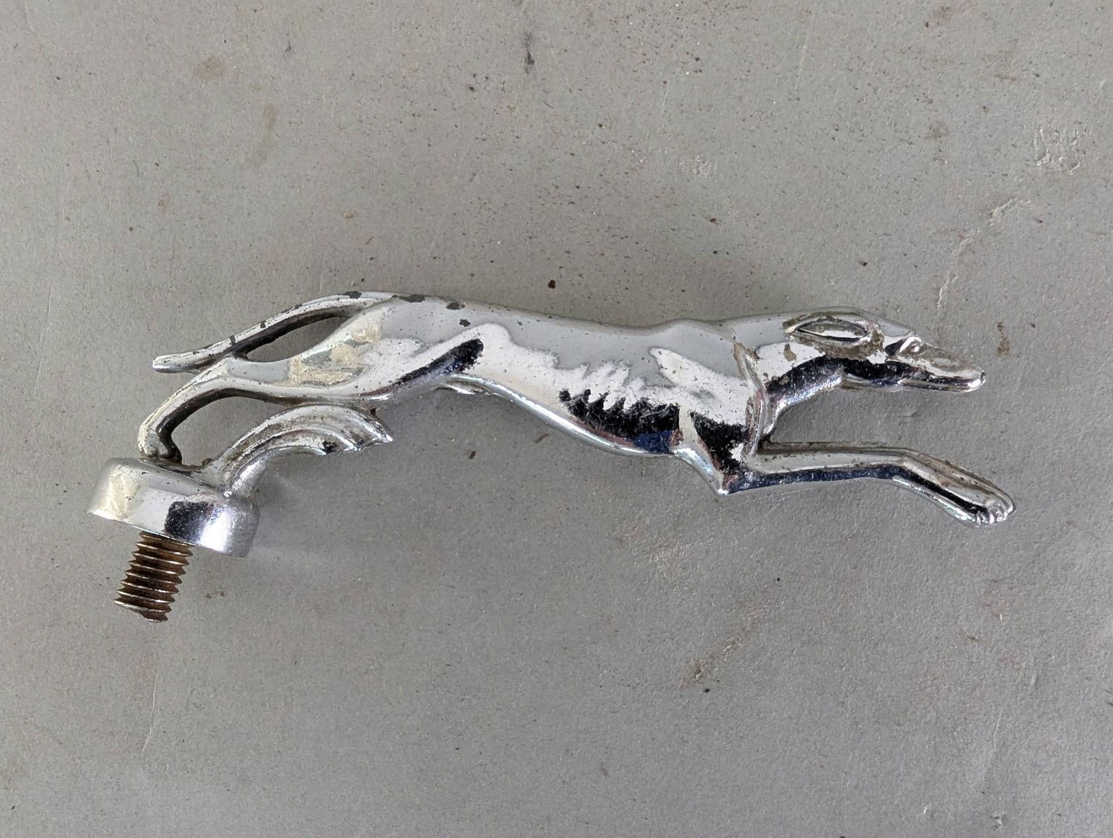 Ford Lincoln Greyhound Hood Ornament by Gorham Manufacturing Company: Ford Lincoln Greyhound hood ornament, measuring 5 1/2 inches wide x 2 high x 2 deep, made of chrome-plated metal. Produced by the Gorham Manufacturing Company, a renowned silversmithing firm, this pie